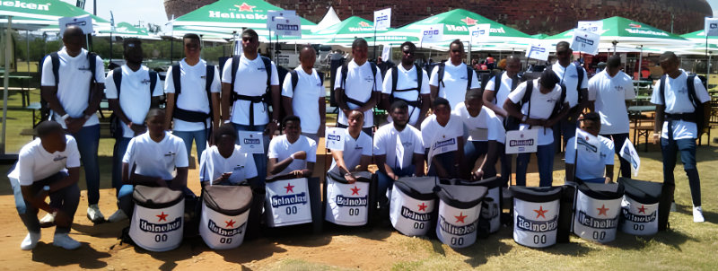Beer vendor backpack enabling on-the-go beverage service at Birmingham food festival.